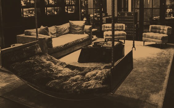 A darkened studio lounge lit in warm bronze.