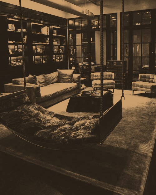 A darkened studio lounge lit in warm bronze.