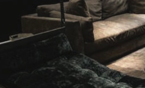 A low-lit lounge sofa in close view.